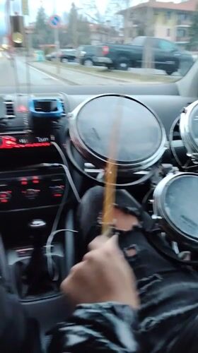 Passenger carries drum set in car through Bansko streets