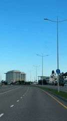 Vehicle travels multi-lane road in Sirius, Russia under clear skies
