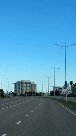 Vehicle travels multi-lane road in Sirius, Russia under clear skies