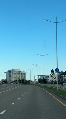 Vehicle travels multi-lane road in Sirius, Russia under clear skies