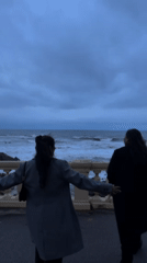 Two people observed at ocean overlook in Porto