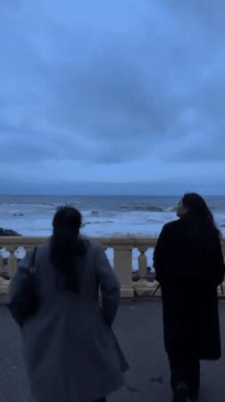 Two people observed at ocean overlook in Porto