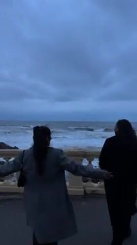 Two people observed at ocean overlook in Porto