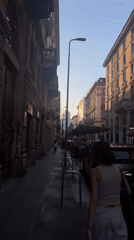 Evening scenes captured in Milan: street walker, restaurant dining