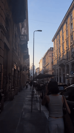 Evening scenes captured in Milan: street walker, restaurant dining