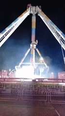 Carnival swing ride in action at a Russian fairground at night