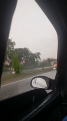Rainy afternoon traffic documented from moving vehicle in Abuja