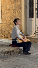 Street music and nightfall settle over Budva's old town