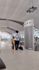 Uniformed worker walks through modern facility in Thailand