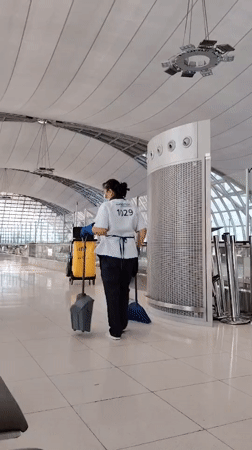Uniformed worker walks through modern facility in Thailand