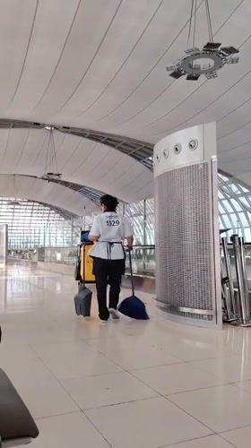 Uniformed worker walks through modern facility in Thailand