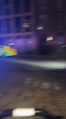 Police vehicles respond to nighttime incident on London street