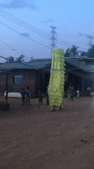 Rural village gathering features colorful decorated structures at dusk