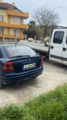 Blue Opel parked next to loaded pickup in Tsarevo