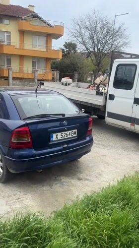 Blue Opel parked next to loaded pickup in Tsarevo