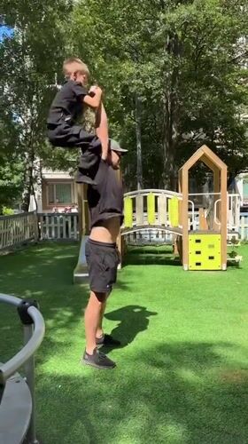 Shoulder-standing balance act on a Moscow playground turf