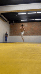 Young athlete performs acrobatic training session in Krasnoyarsk gym