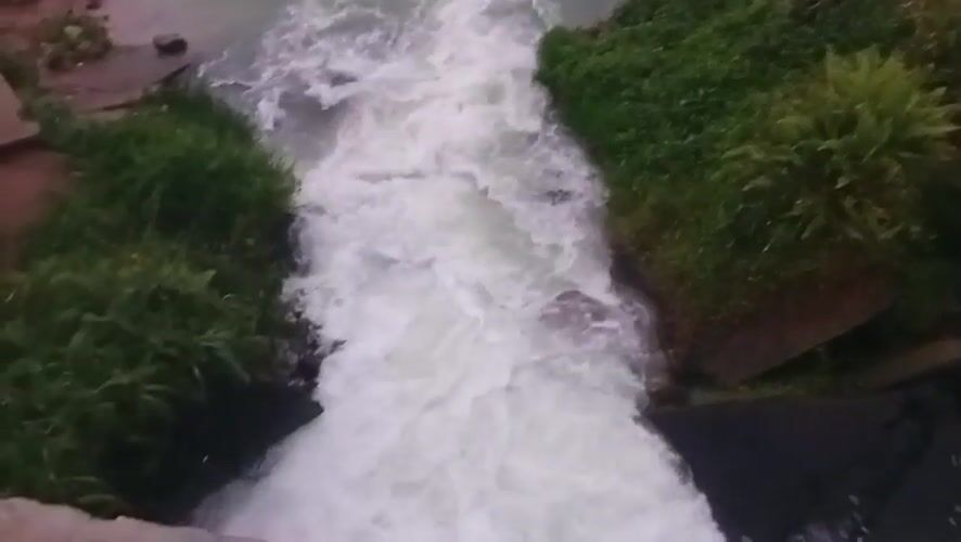 Rushing waterway documented in Ihiagwa, Nigeria amid lush vegetation