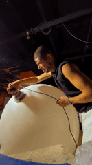 Sanding a large white sphere in Karaganda, Kazakhstan