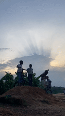 Children play on dirt mound in Unwana, Nigeria
