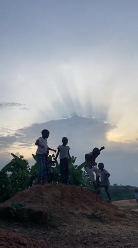 Children play on dirt mound in Unwana, Nigeria