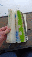 Artist flips through colorful sketchpad drawings