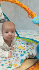 Baby plays on colorful mat in Andreyevo, Russia