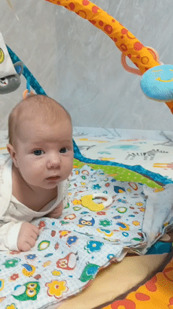 Baby plays on colorful mat in Andreyevo, Russia