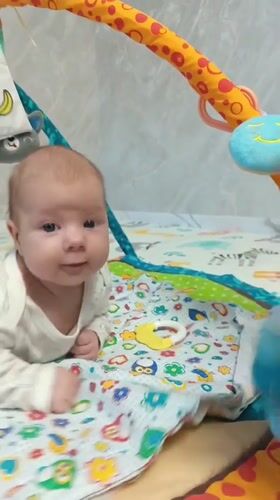 Baby plays on colorful mat in Andreyevo, Russia