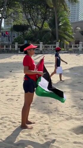 Palestinian flag held on a Nha Trang beach