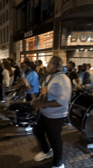 Amsterdam street celebration features drums, dancing, fireworks