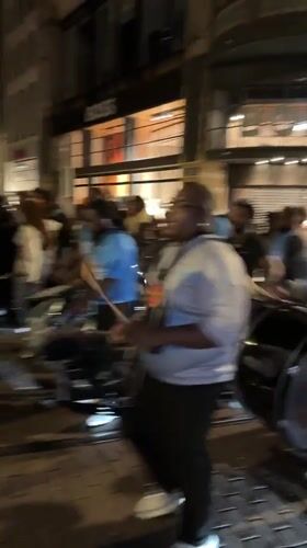 Amsterdam street celebration features drums, dancing, fireworks