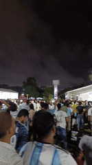Dhaka crowd watches live soccer under big screen at night