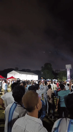 Dhaka crowd watches live soccer under big screen at night