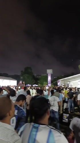 Dhaka crowd watches live soccer under big screen at night