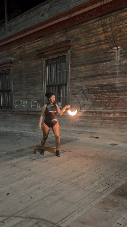 Fire-breathing act outside a graffiti-covered building in Iquique