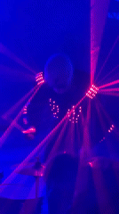 Light-up drummer performs for dancing crowd at laser-lit Moldova event
