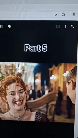 A video clip shows a scene from the movie Titanic, labeled "Part 5". The first shot focuses on a woman with red curly hair and a large smile, wearing a necklace and a dress. The second shot shows the woman leaning over the shoulder of a man with blonde hair, who is looking down at a book or drawing. Both individuals are dressed in period clothing. The background suggests an indoor setting with other people in formal attire, likely on a ship.
