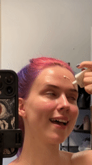 Purple-haired individual creates beauty content in Zagreb