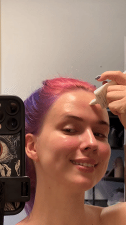 Purple-haired individual creates beauty content in Zagreb