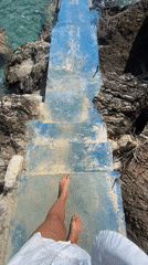 Barefoot visitor enjoys quiet moment at Montenegro rocky shore