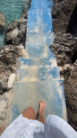 Barefoot visitor enjoys quiet moment at Montenegro rocky shore