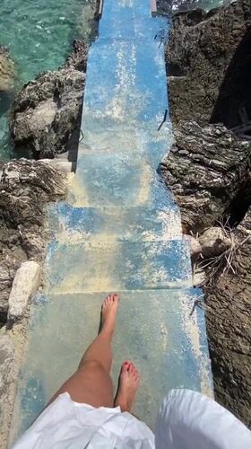 Barefoot visitor enjoys quiet moment at Montenegro rocky shore