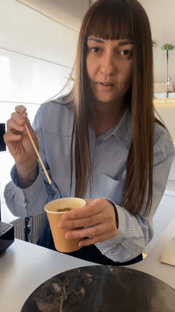 Woman adds cinnamon to coffee in Votkinsk cafe