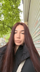 Woman takes selfies on street in Stara Zagora, Bulgaria