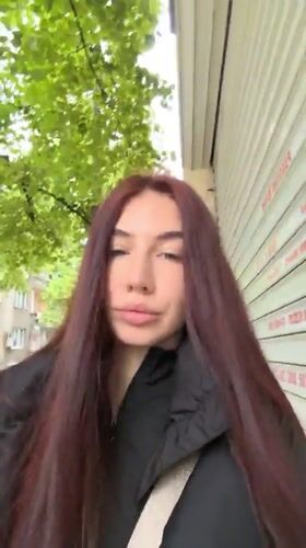 Woman takes selfies on street in Stara Zagora, Bulgaria