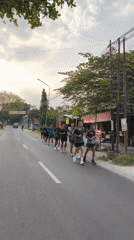 Group jogging in formation along a road in rural Indonesia