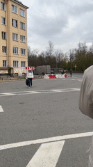 Woman crosses street in overcast Saint Petersburg afternoon