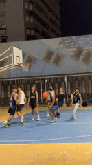 Nighttime scenes captured at Málaga basketball court and waterfront promenade