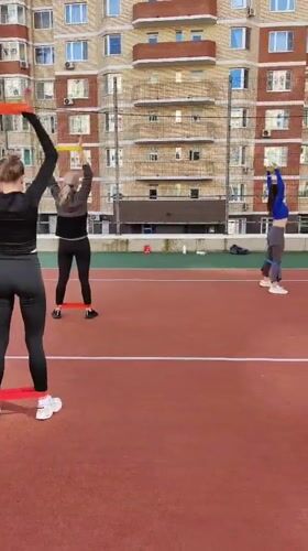 Friday morning resistance band workout on a red sports court
